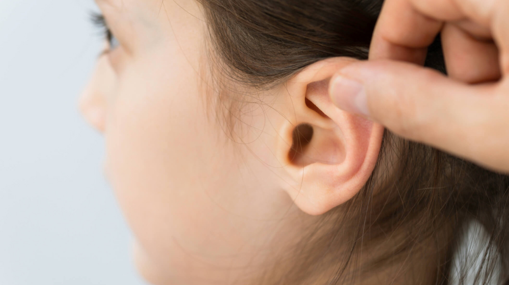 Child having her ears looked iside
